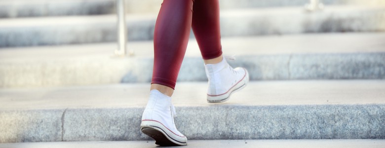 Close up of woman walking up stairs