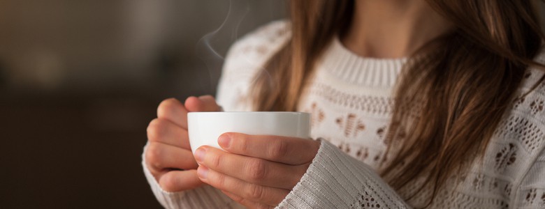 A woman relaxing with a cup of tea.