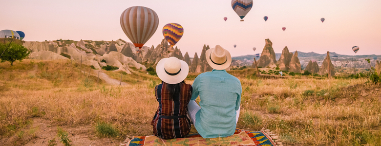 A couple watching hot air balloons in Turkey.