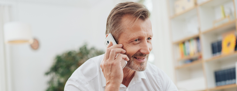 A man taking a phone call at home.