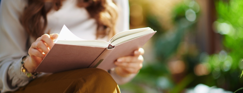 Close-up of a woman reading a book