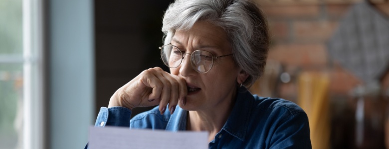 A woman reading a letter.