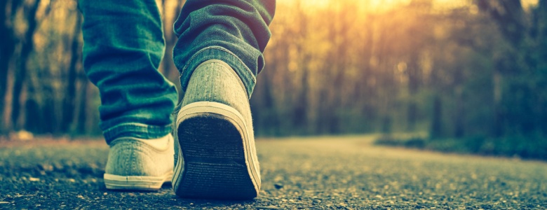 A close-up of someone walking on a path.