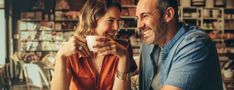 A couple laughing in a café.