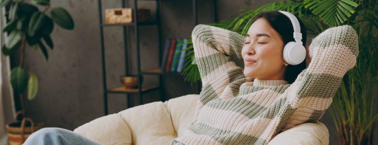 A woman relaxing with headphones on.