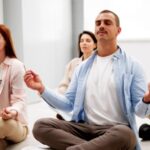 Group of employees meditate in an office