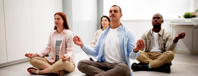 Group of employees meditate in an office