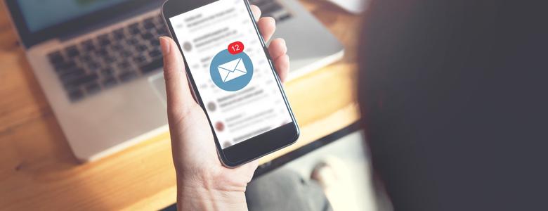 A person looking at their email on their phone.