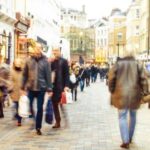 People walking down a high street.