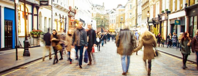 People walking down a high street.