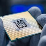 A hand holding a CPU.