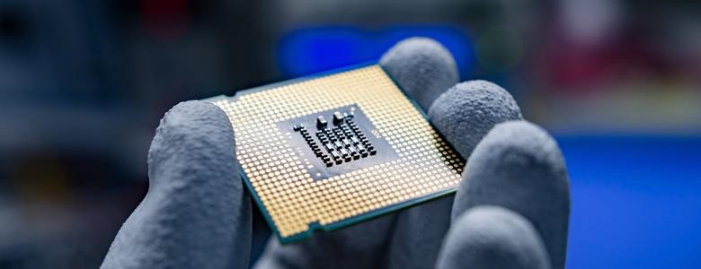 A hand holding a CPU.