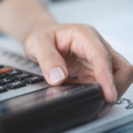 A person using a calculator.