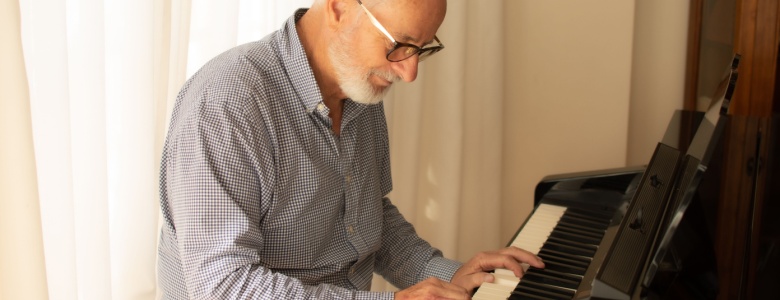 A man practising playing the piano.