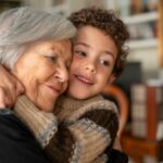 A woman hugging her grandchild.