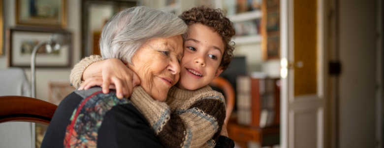 A woman hugging her grandchild.
