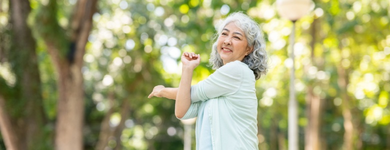 A woman stretching in a park.