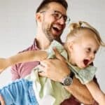 A father playing with his young daughter
