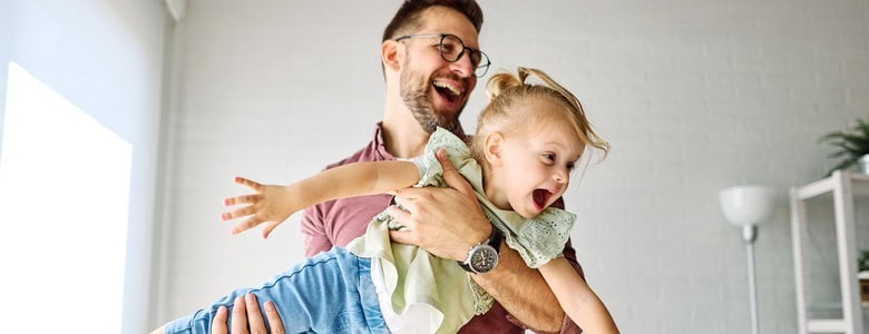 A father playing with his young daughter