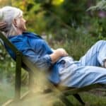 A woman relaxing in a garden.