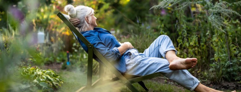 A woman relaxing in a garden.