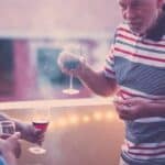 A group of people taking and drinking wine.