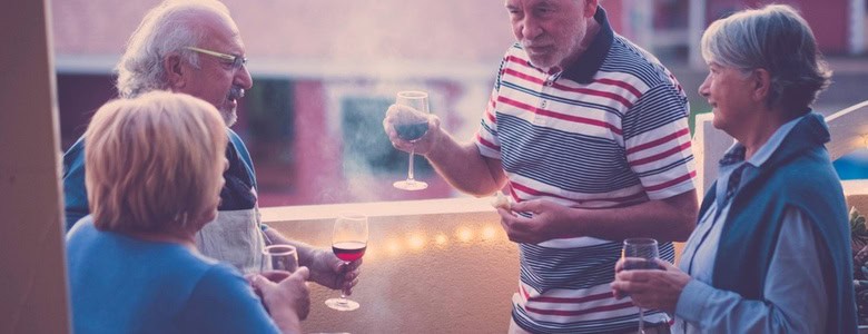 A group of people taking and drinking wine.